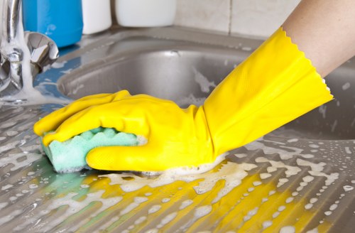 Professional office cleaner maintaining a reception area in SW2
